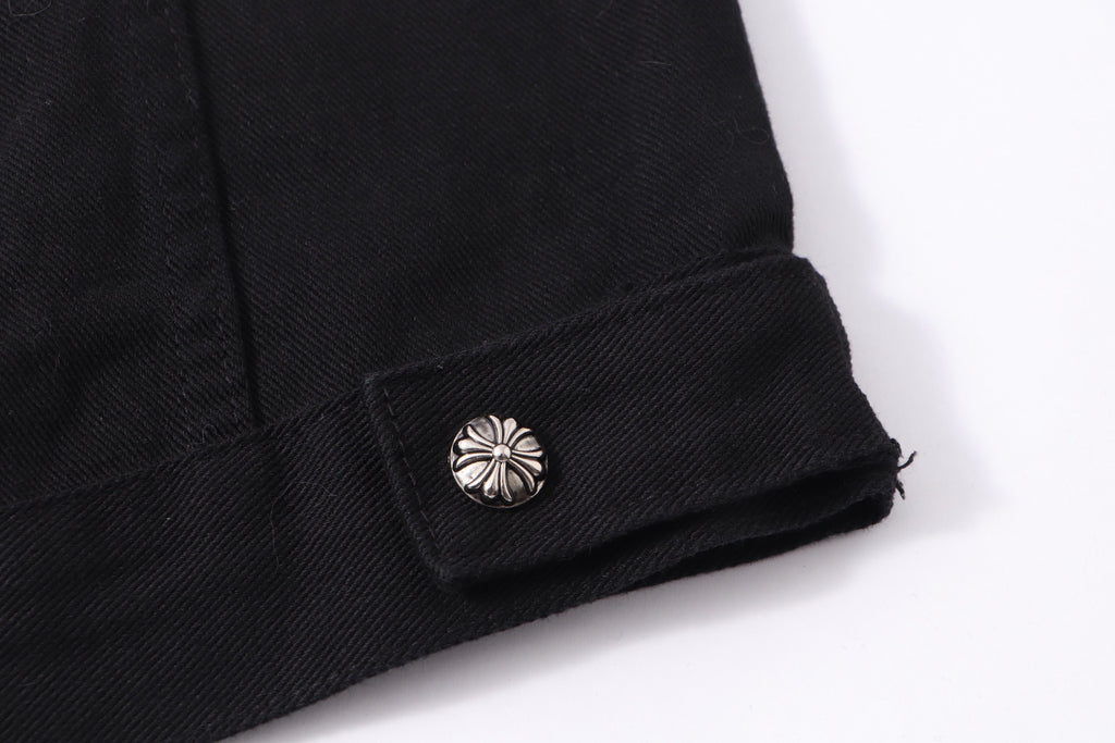 Black denim jacket cuff with metallic snap and folded hem