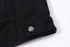 Black denim jacket cuff with metallic snap and folded hem