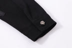 Black denim jacket sleeve hem with metallic snap button