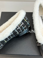 Women’s Chanel loafer detail, black tweed side with white sherpa trim and logo hardware
