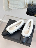 Women’s Chanel loafers on box, black leather with white shearling lining and logo