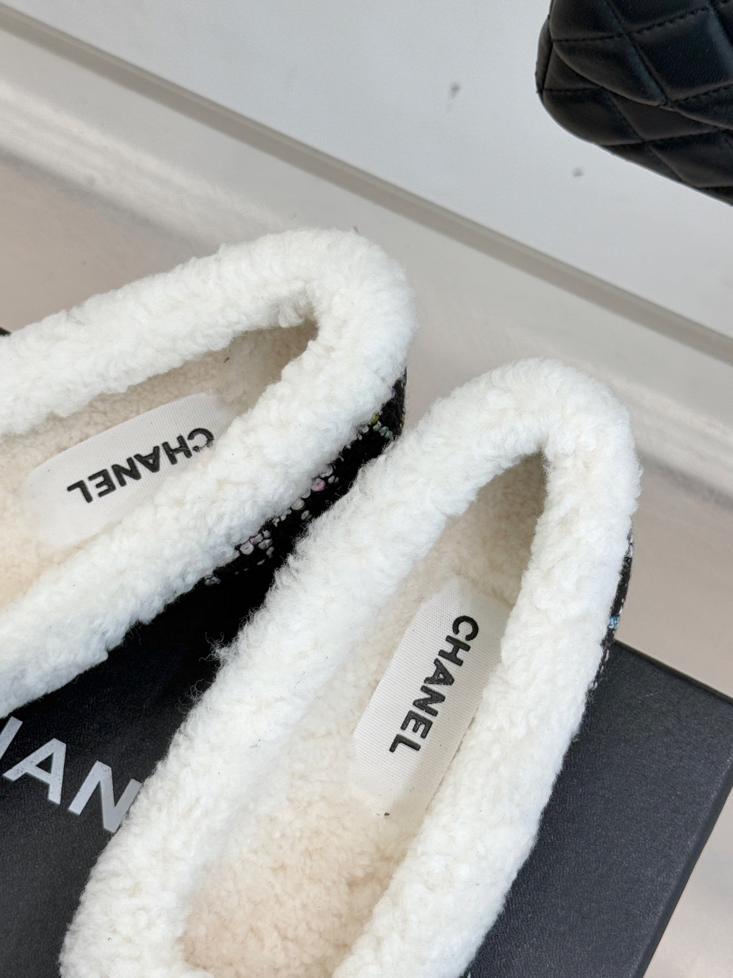 Women’s Chanel loafer interior view, white sherpa lining with Chanel name print