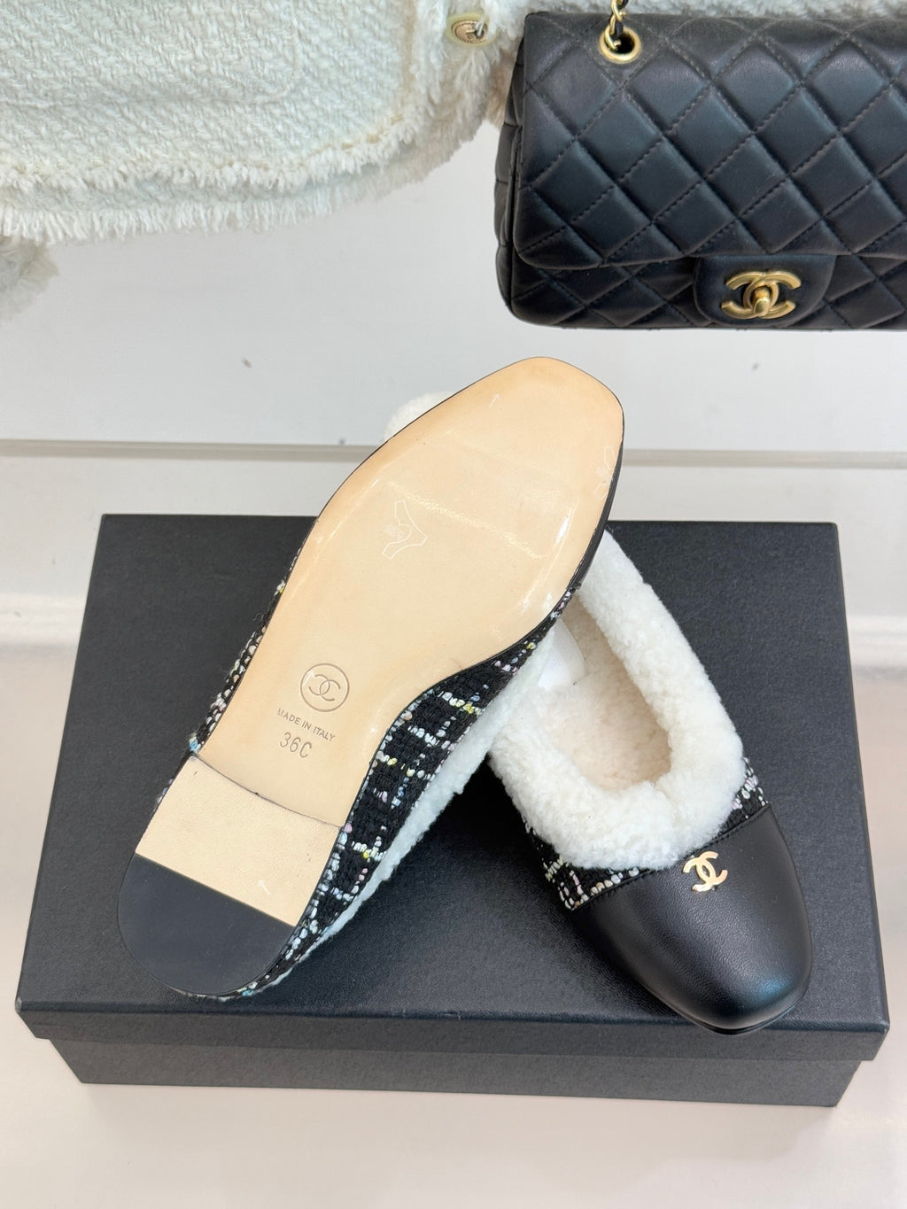 Women’s Chanel loafer sole view, beige bottom on box and black leather with sherpa trim