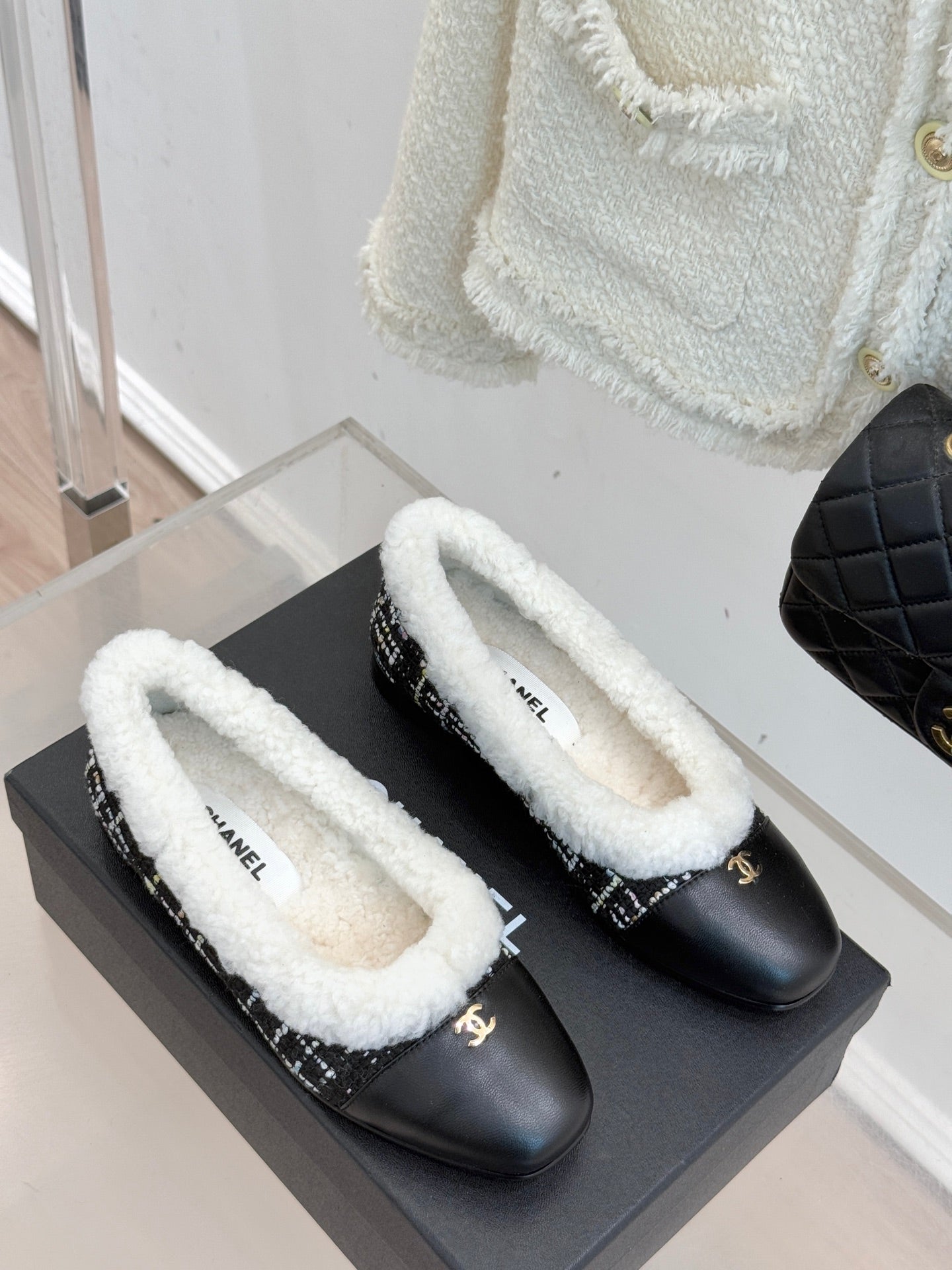 Pair of women’s Chanel loafers, black uppers with white sherpa lining and tweed trim