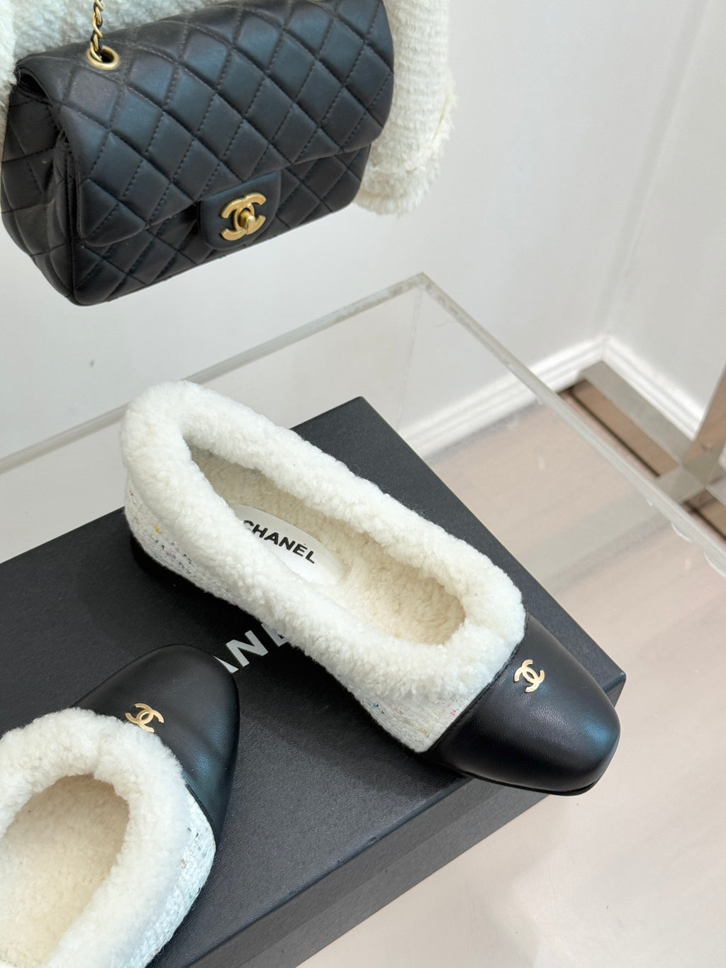 Women's Chanel slip-on flats with black leather and light blue shearling lining