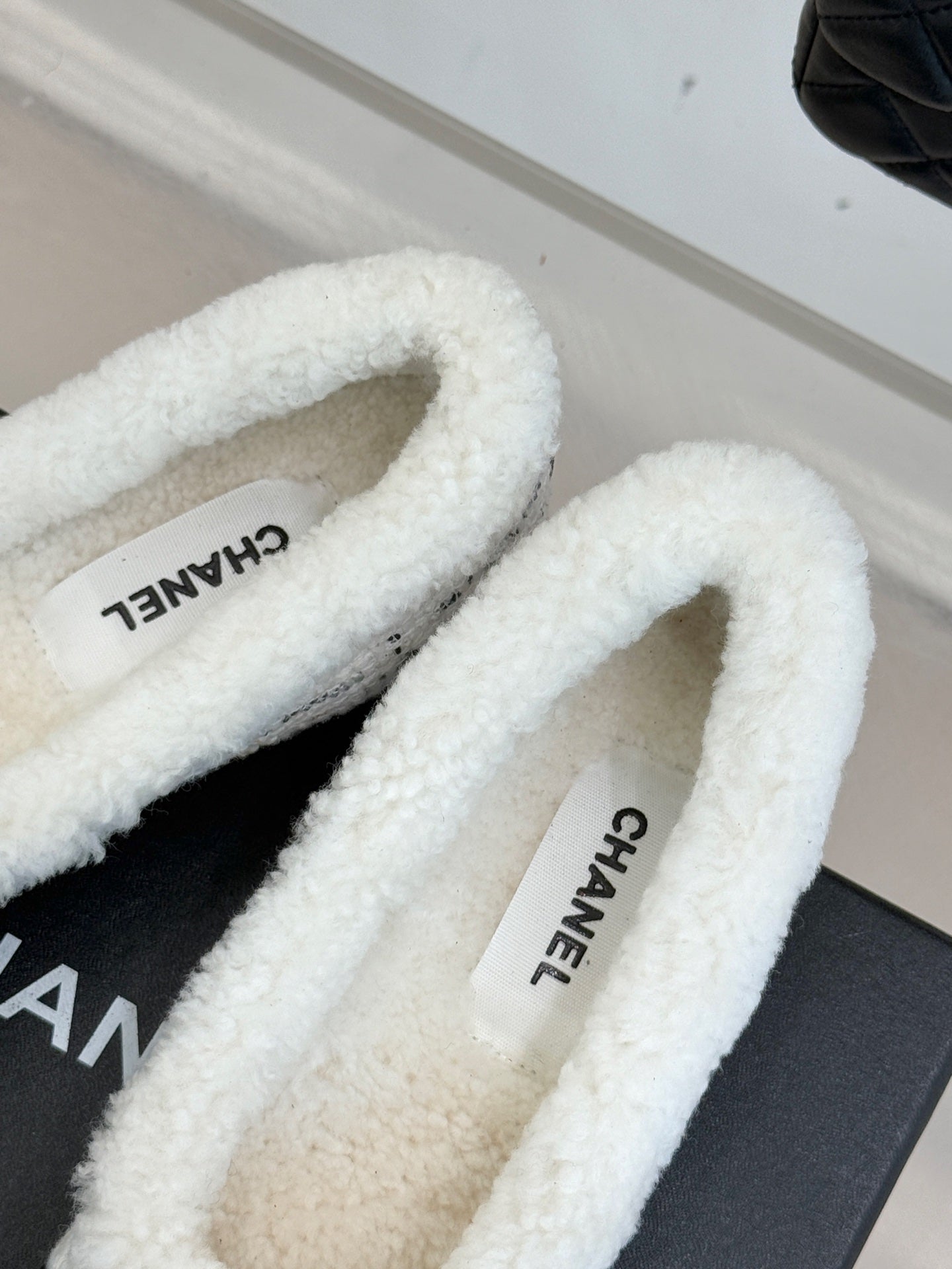 Women's Chanel flats with white shearling lining and CHANEL label on insole