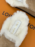 Louis Vuitton ladies shearling slide, white faux-fur strap with brand label and tan footbed