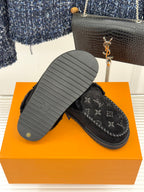 Louis Vuitton black monogram loafers with visible outsole tread