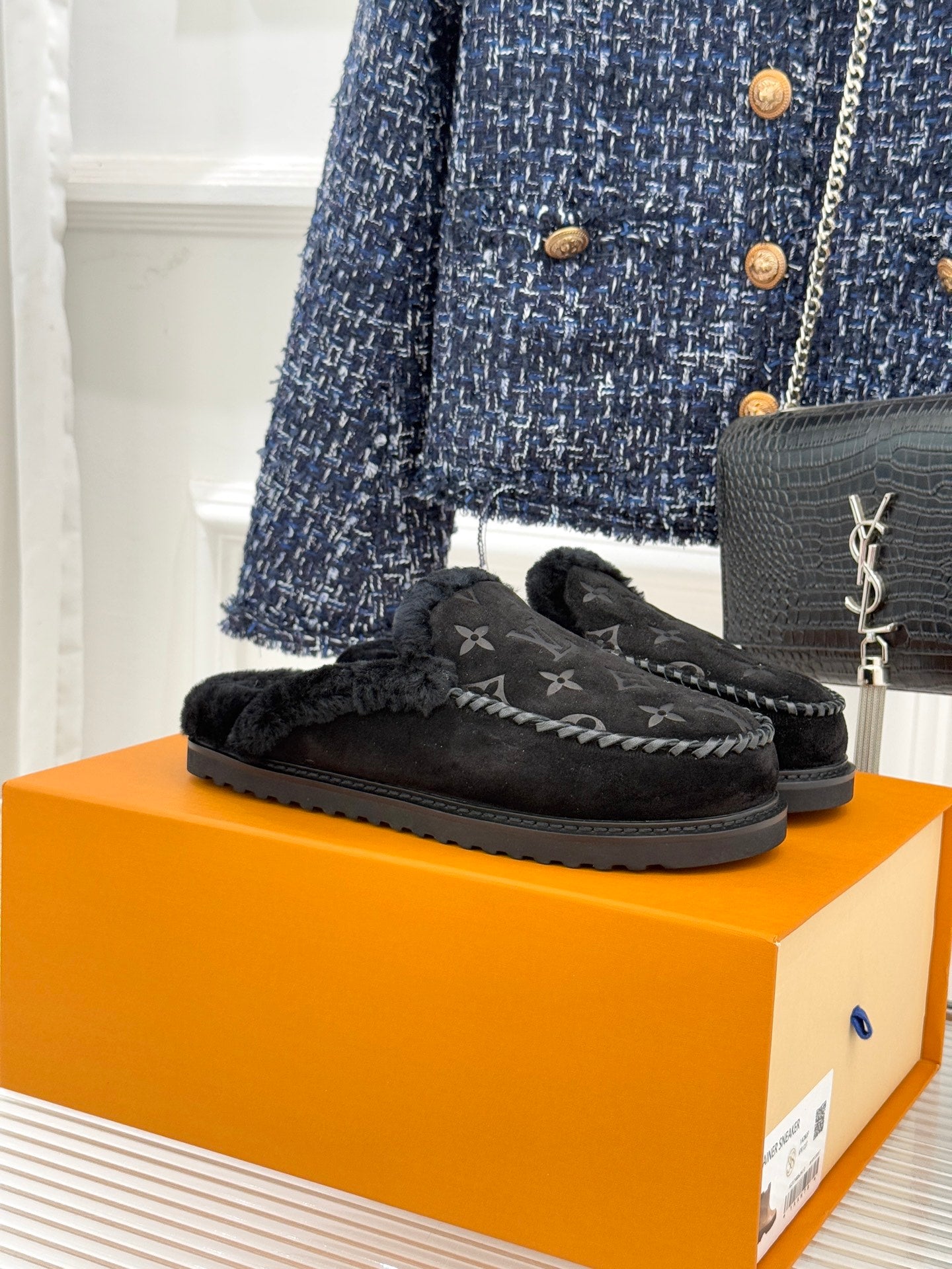 Louis Vuitton monogram slip-on loafers with black faux shearling lining