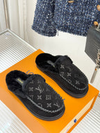 Louis Vuitton black monogram slip-on loafers on an orange box