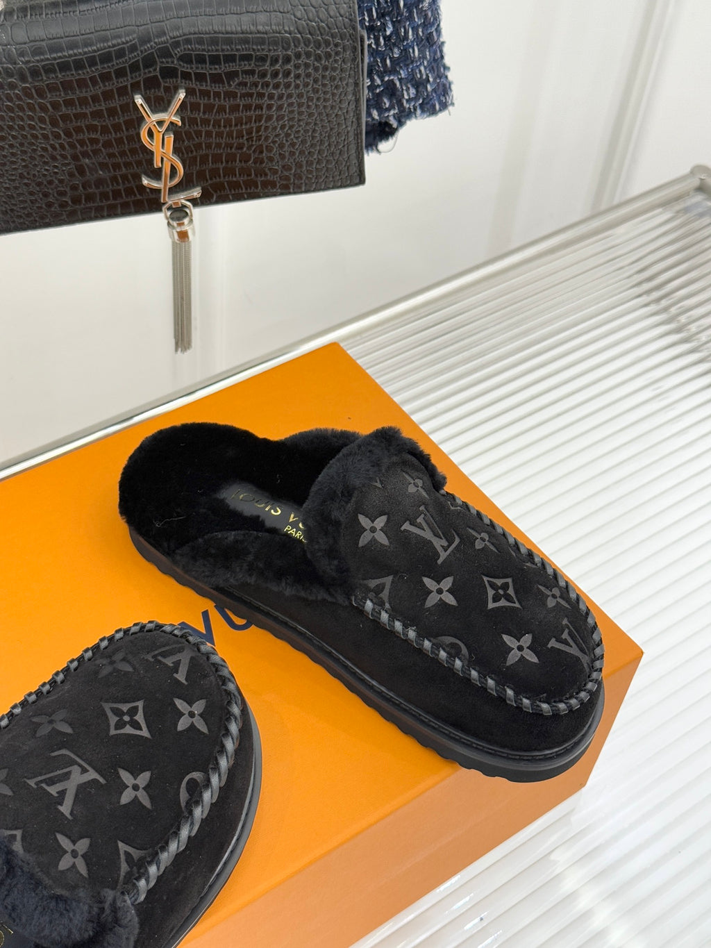 Louis Vuitton black monogram loafers with shearling lining, side angle
