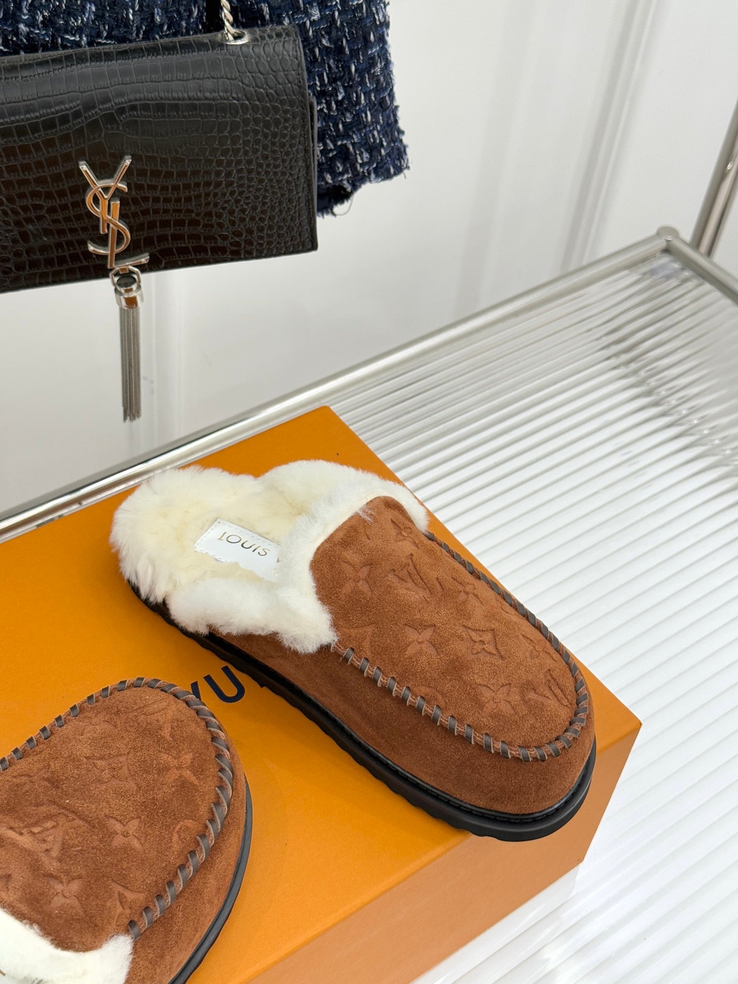 Brown suede shearling loafer with white fur collar and black sole