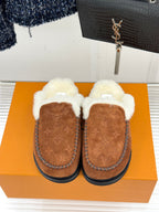 Brown suede slip-on loafers with thick white shearling trim and rounded toe