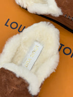 White shearling interior label on brown suede loafer with cushioned collar