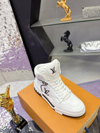 White Louis Vuitton high-top sneaker with LV logo panel and black outsole