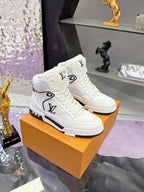 White Louis Vuitton high-top sneakers on an orange box with black side stripe sole