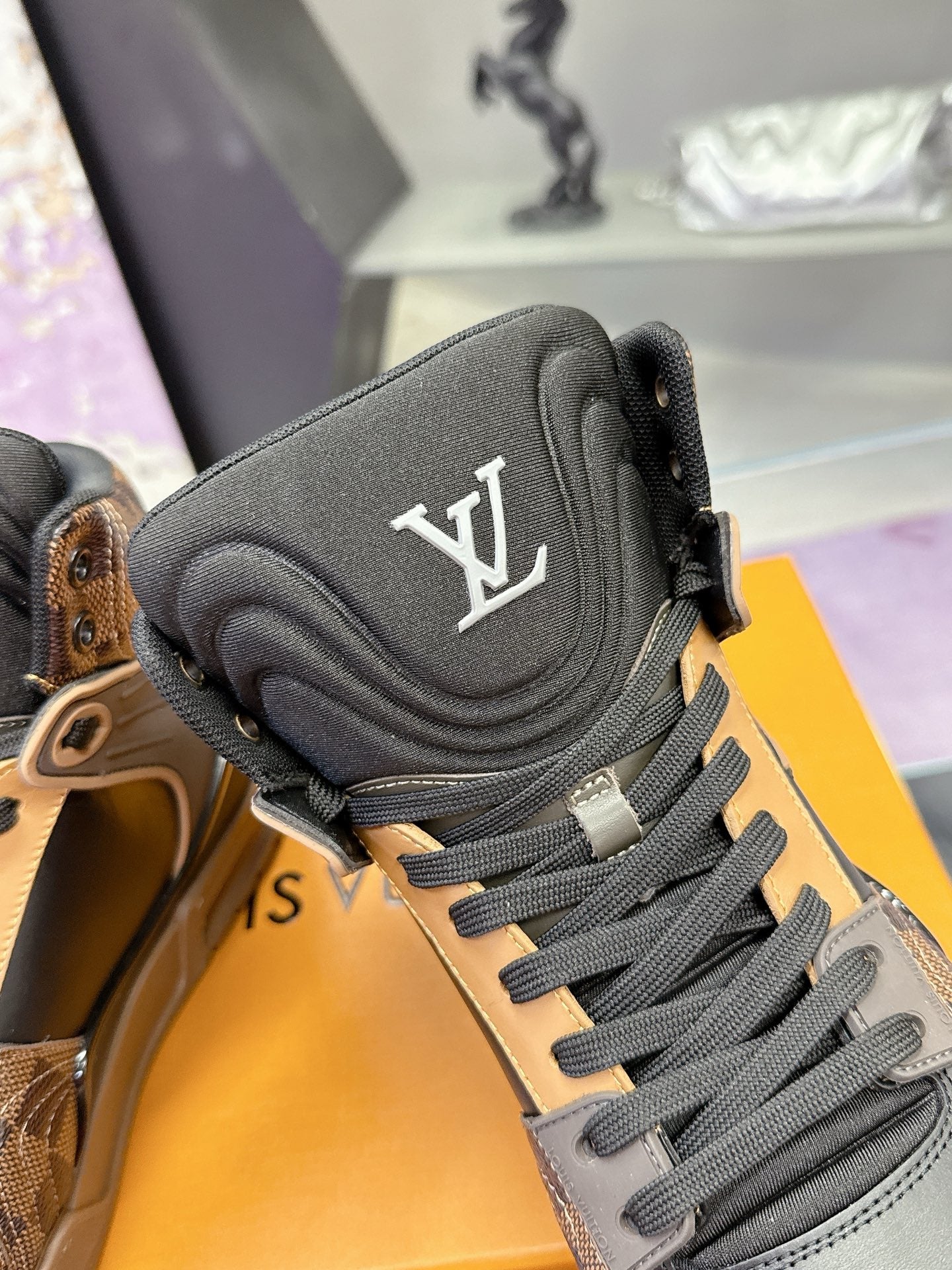 Louis Vuitton ladies high-top sneakers close-up of black padded tongue with LV logo