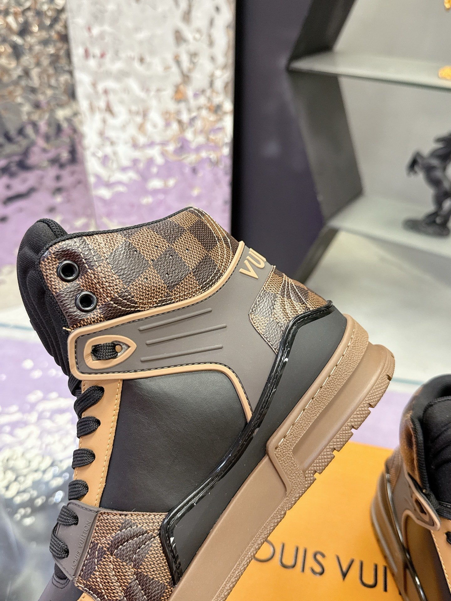 Louis Vuitton ladies high-top sneaker front quarter in tan check pattern with black laces