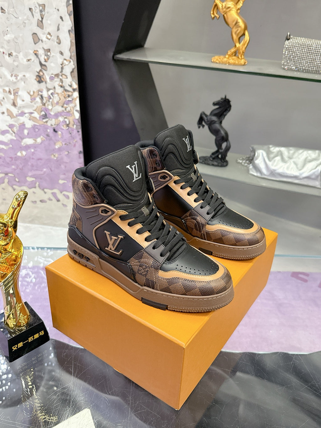 Louis Vuitton ladies high-top sneakers in dark brown and black on display