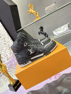 Louis Vuitton high-top sneakers on orange box, dark gray/black with LV side logo and laces
