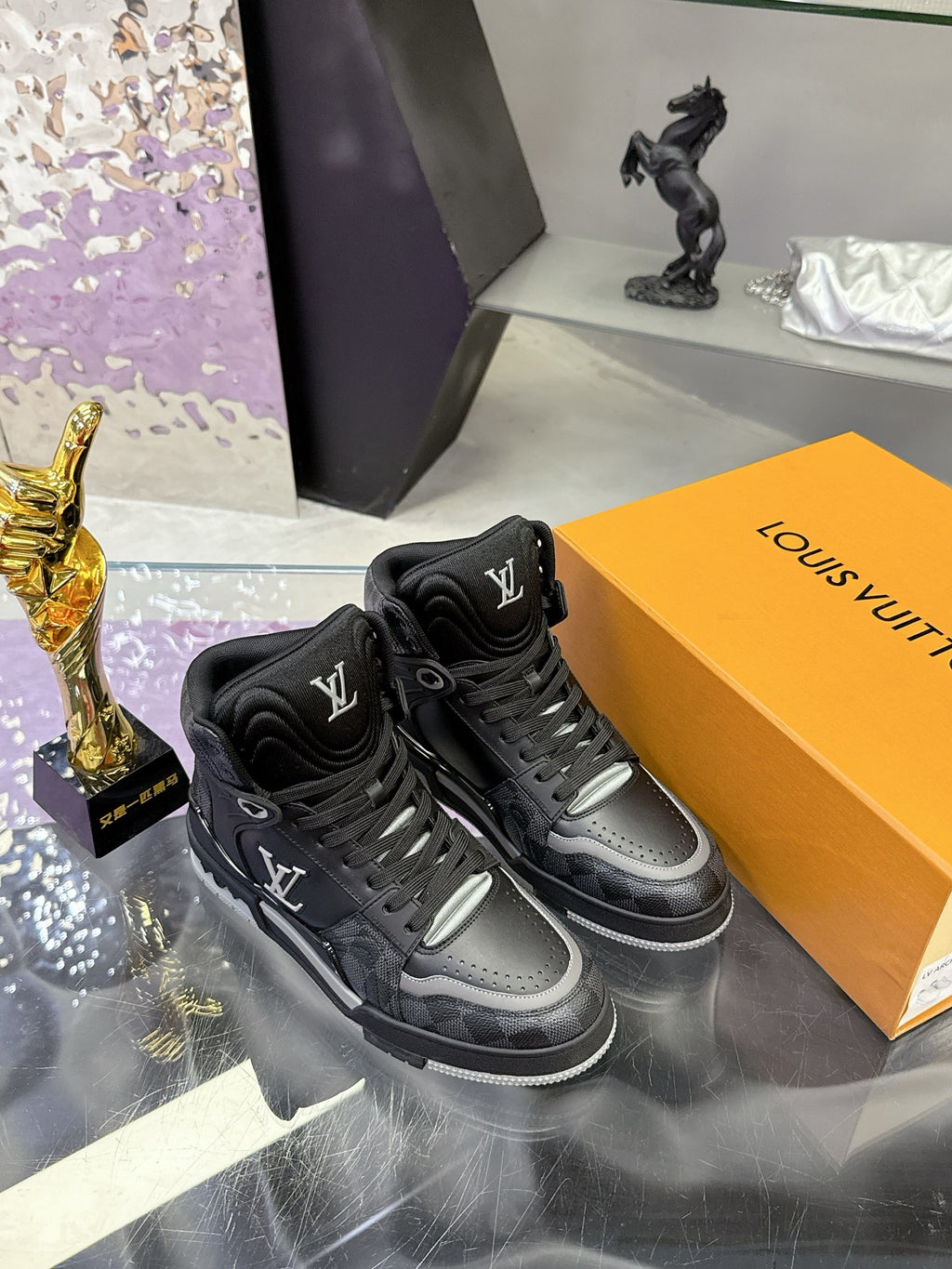 Louis Vuitton high-top sneakers, black with gray accents, lace-up front and embossed LV marks