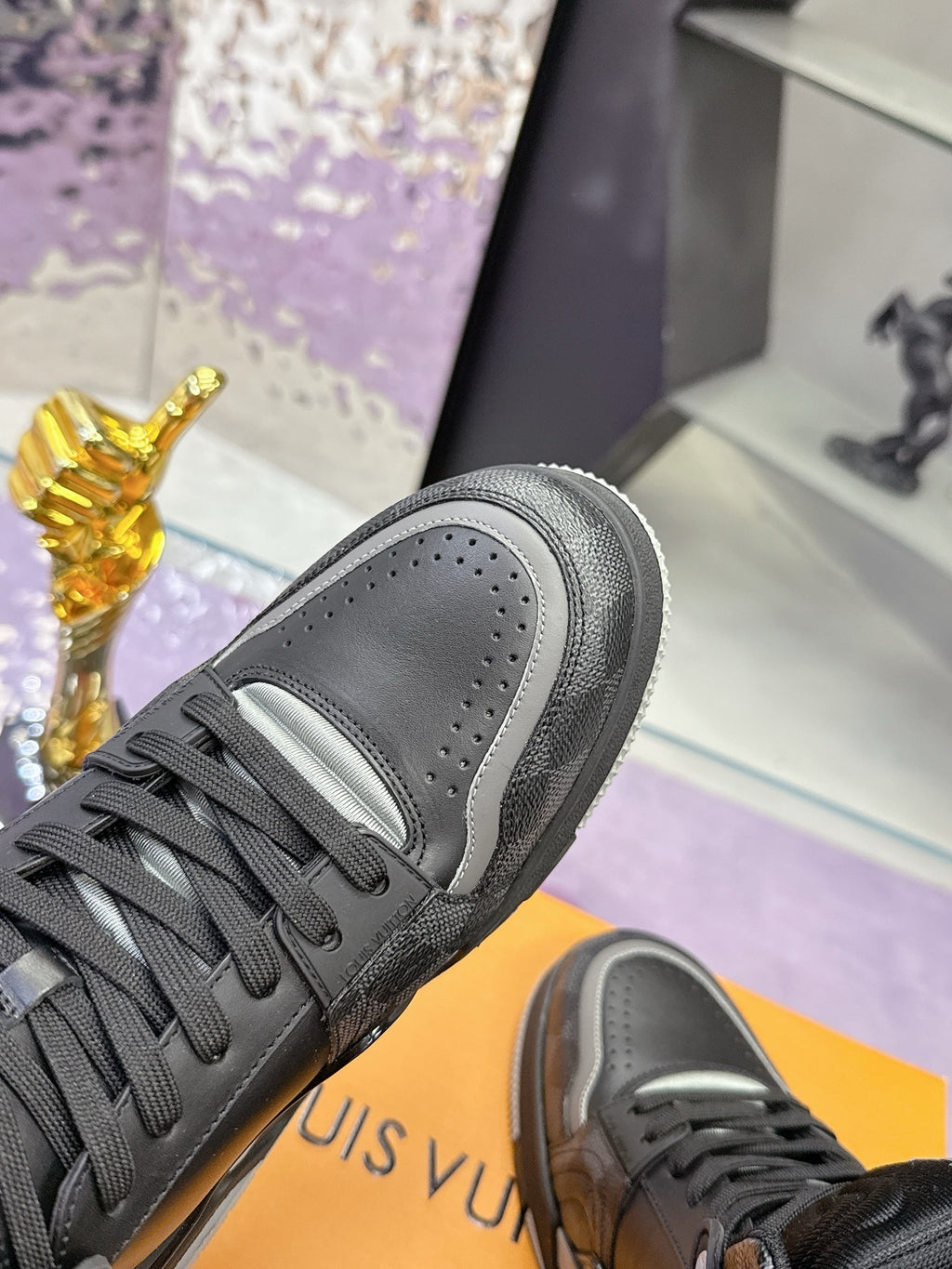 Louis Vuitton sneaker close-up, dark gray/black leather with lace-up and padded collar