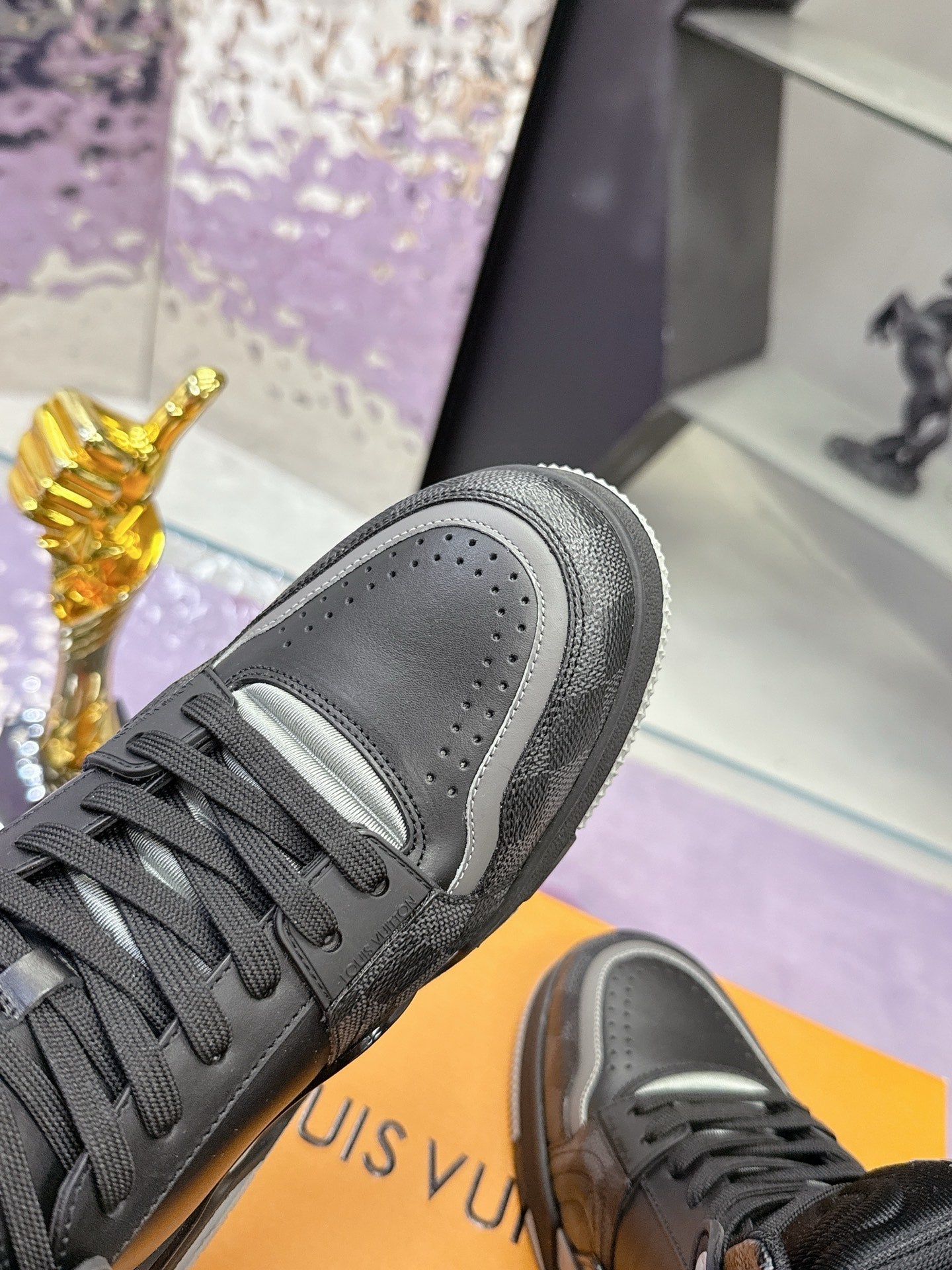 Louis Vuitton sneaker close-up, dark gray/black leather with lace-up and padded collar