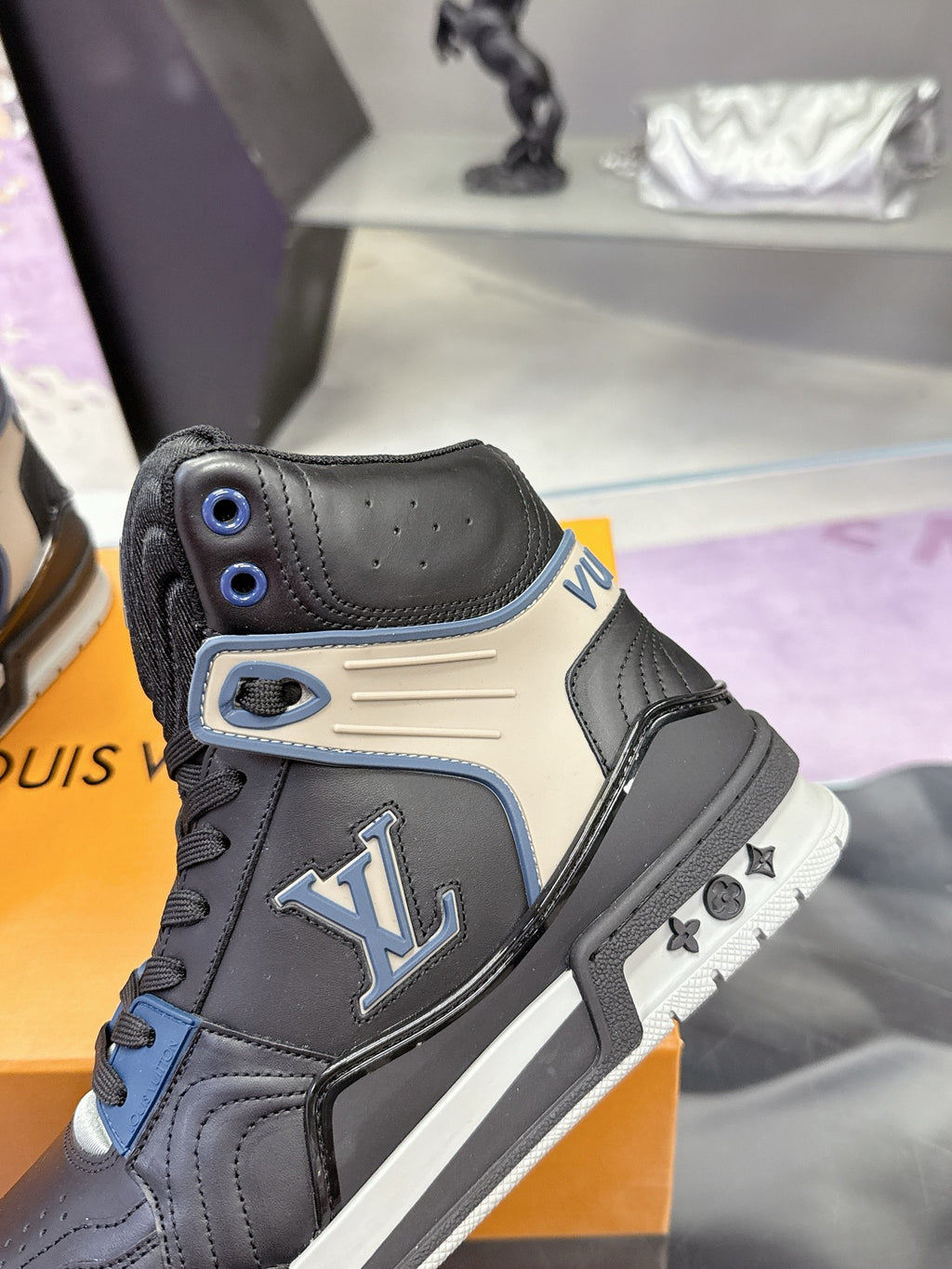 Louis Vuitton high-top sneaker with LV logo patch, black leather and blue eyelets