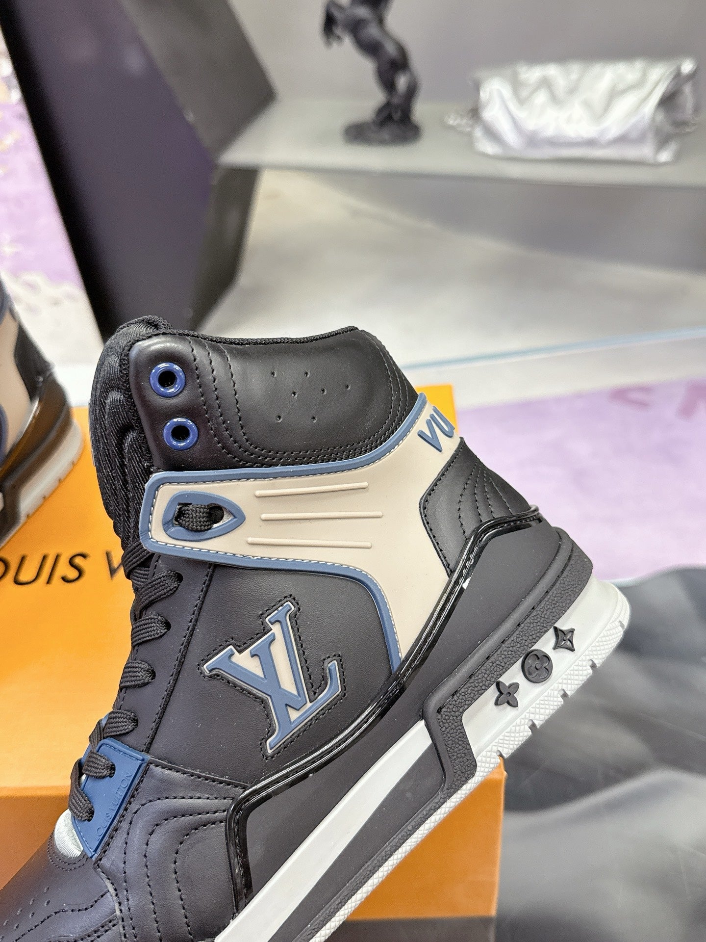 Louis Vuitton high-top sneaker with LV logo patch, black leather and blue eyelets