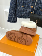 Louis Vuitton women's brown suede slippers underside view with molded monogram rubber sole