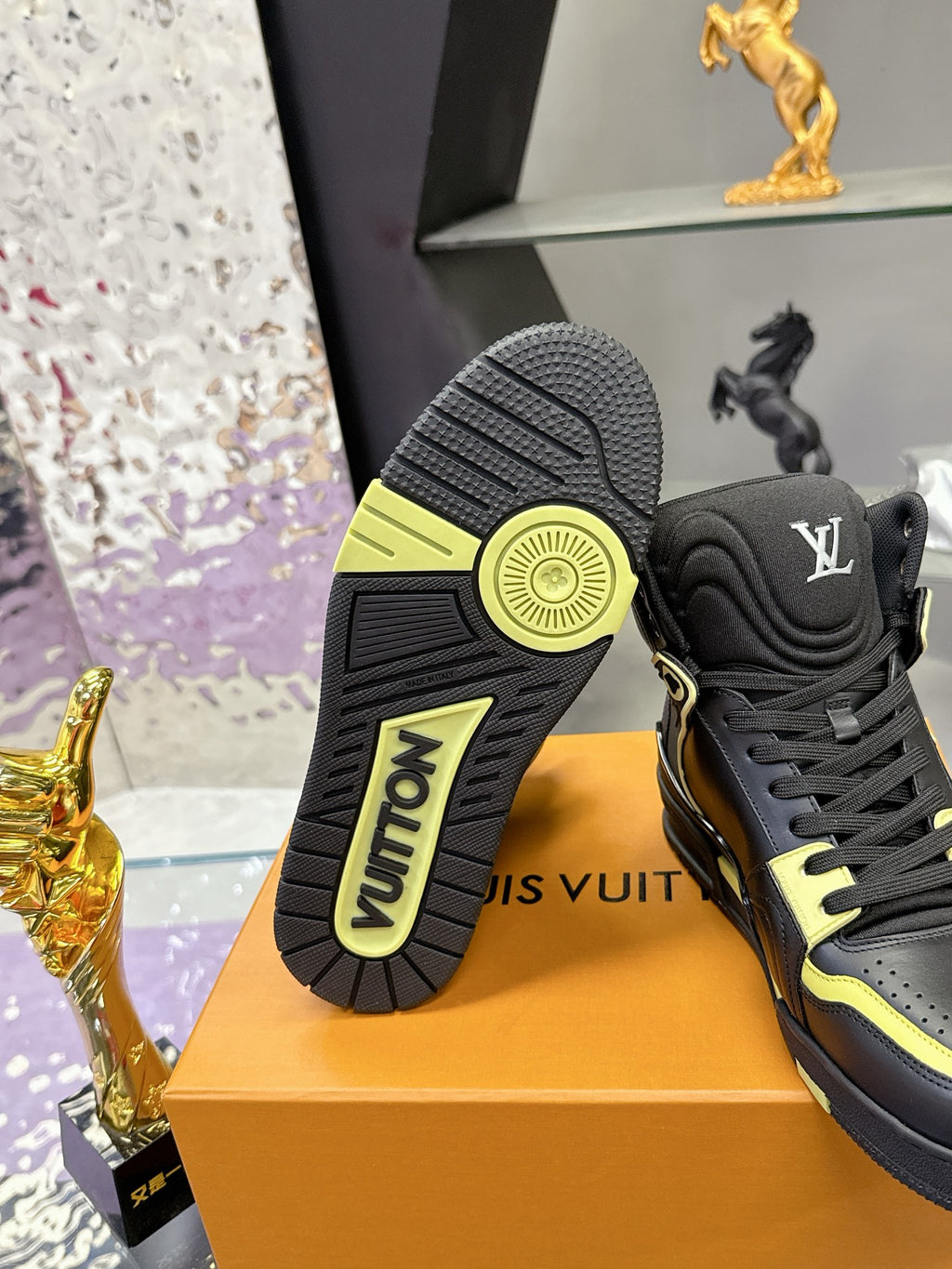 Black high-top sneaker outsole and heel view with neon yellow edge accents
