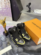 Black high-top sneakers on orange box with neon yellow trim and logo detail