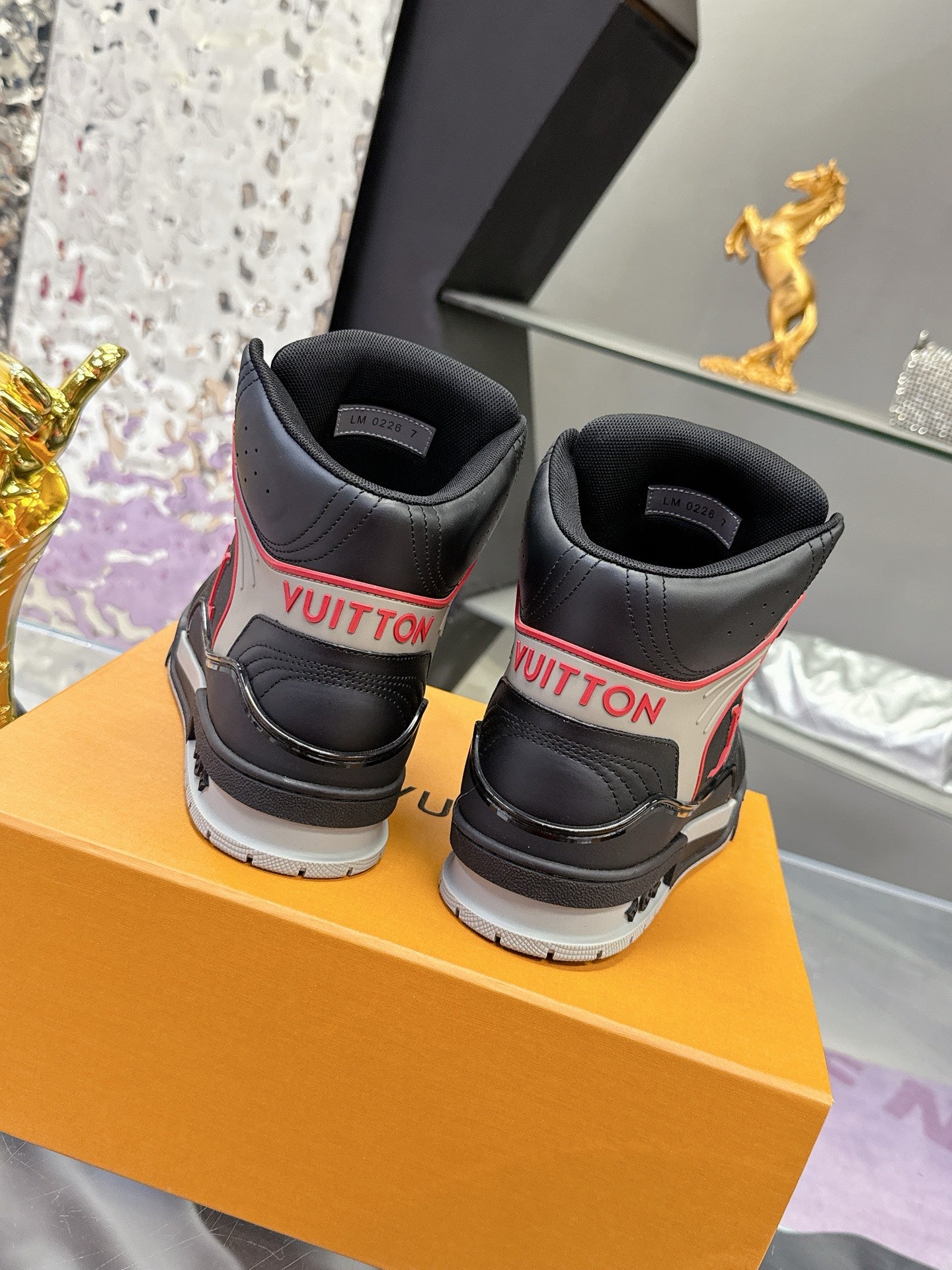 Louis Vuitton high-top sneakers heel view, black with red trim and white outsole
