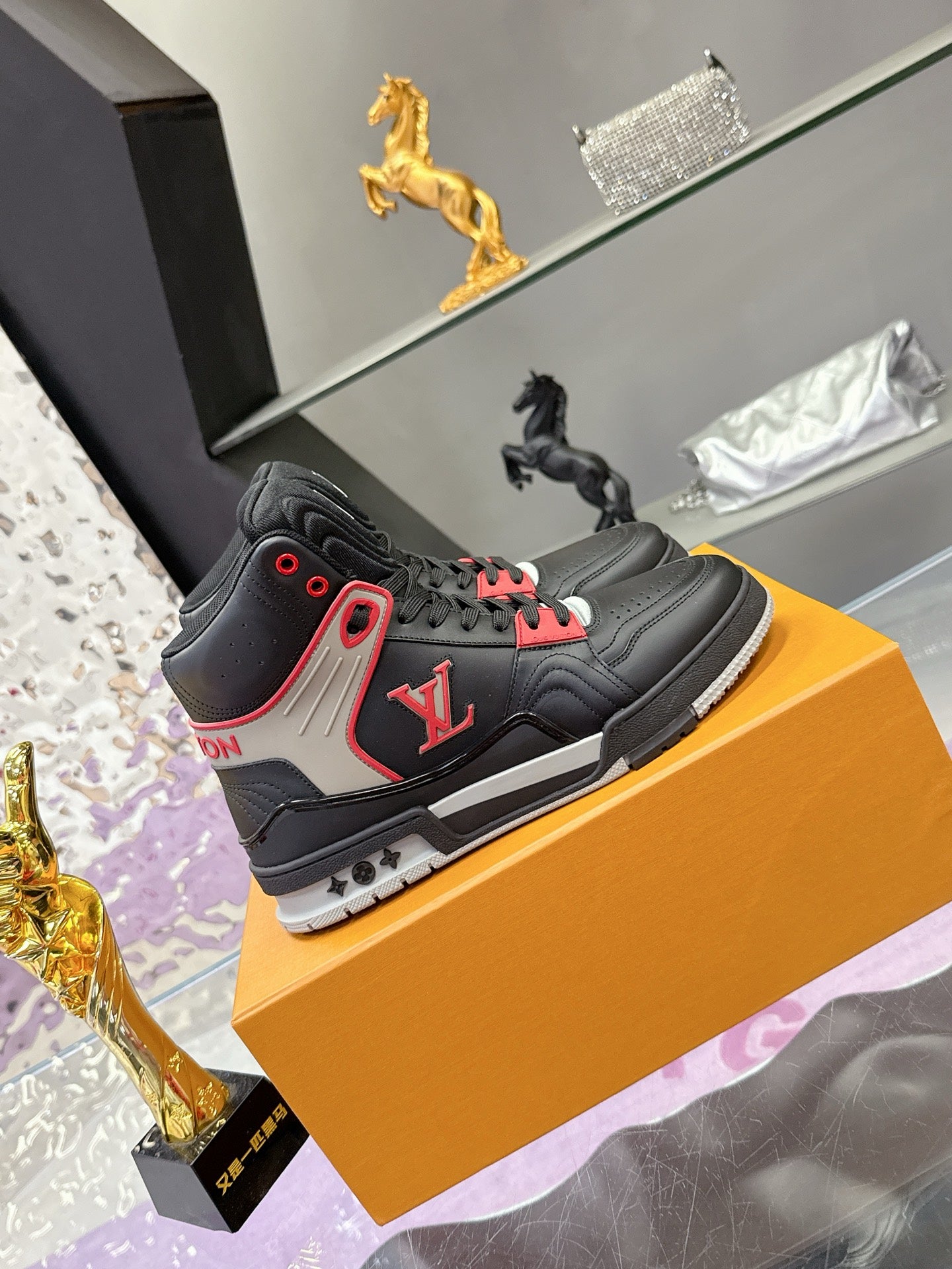 Louis Vuitton high-top sneakers on box, black with white panel and red accents