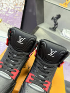 Louis Vuitton high-top sneakers close-up, black uppers with red trim and LV logos