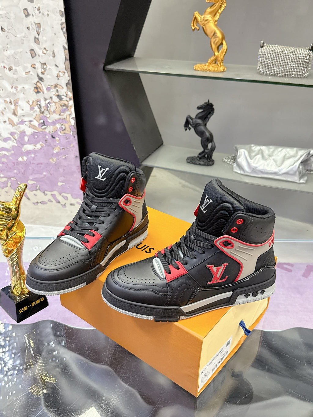 Louis Vuitton high-top sneakers pair, black leather with red and white logo details