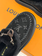 Black monogram loafer upper with gold-tone buckle detail and shearling cuff