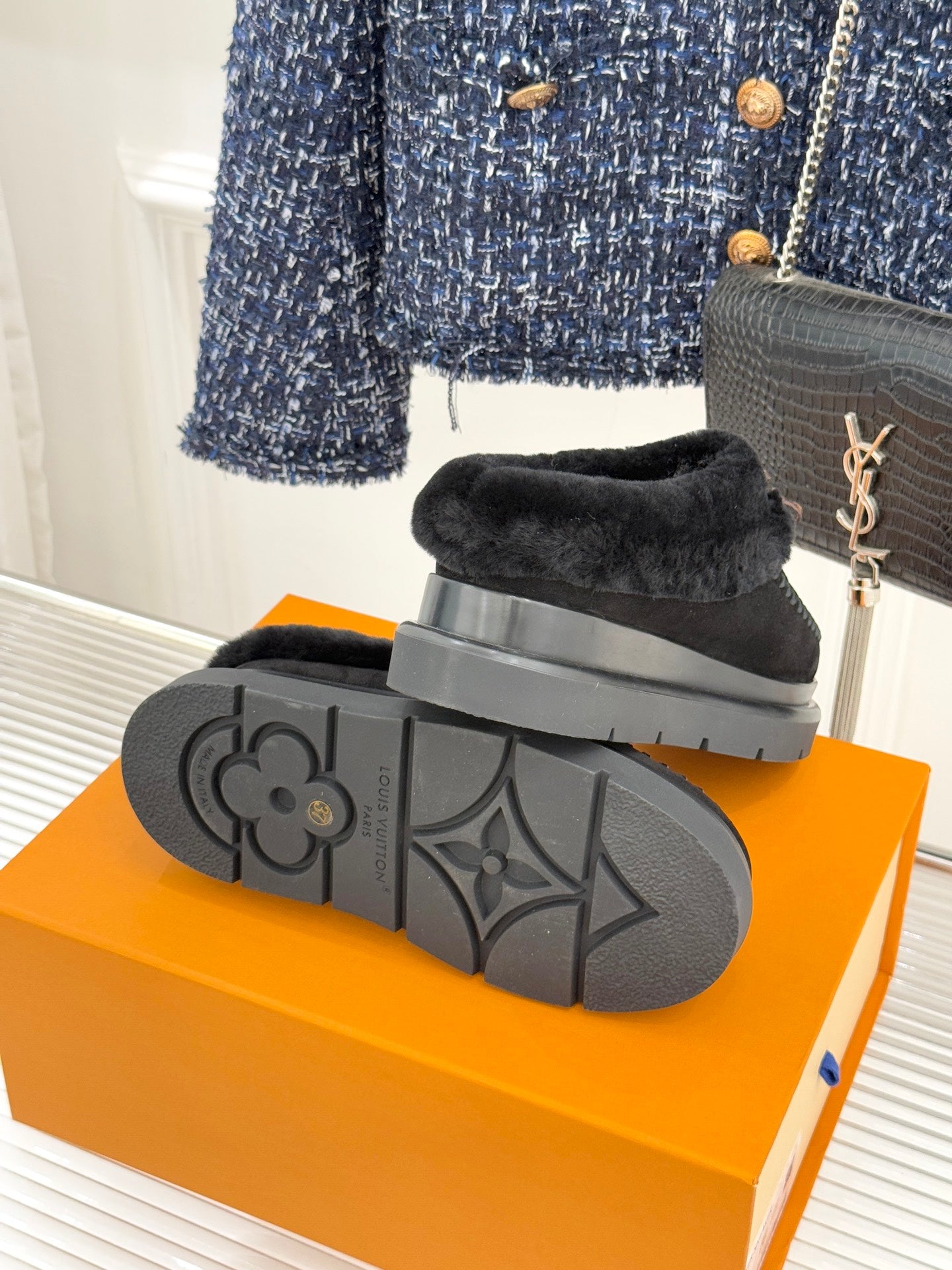 Black rubber outsole of monogram loafer with tread and circular logo detail