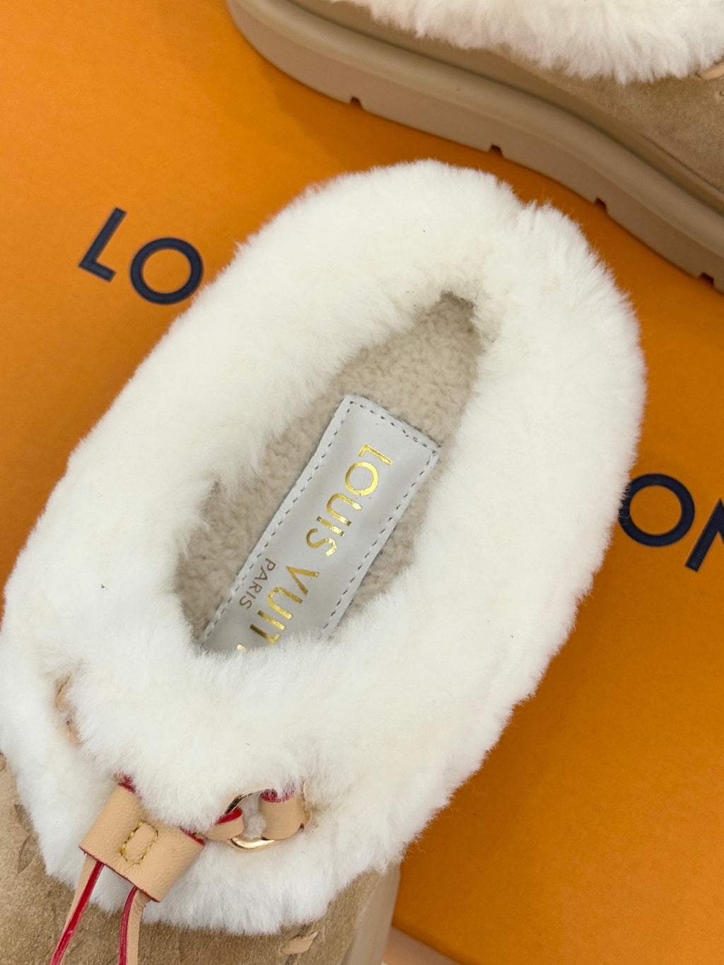 Ladies Louis Vuitton tan suede mule with white shearling upper and insole tag