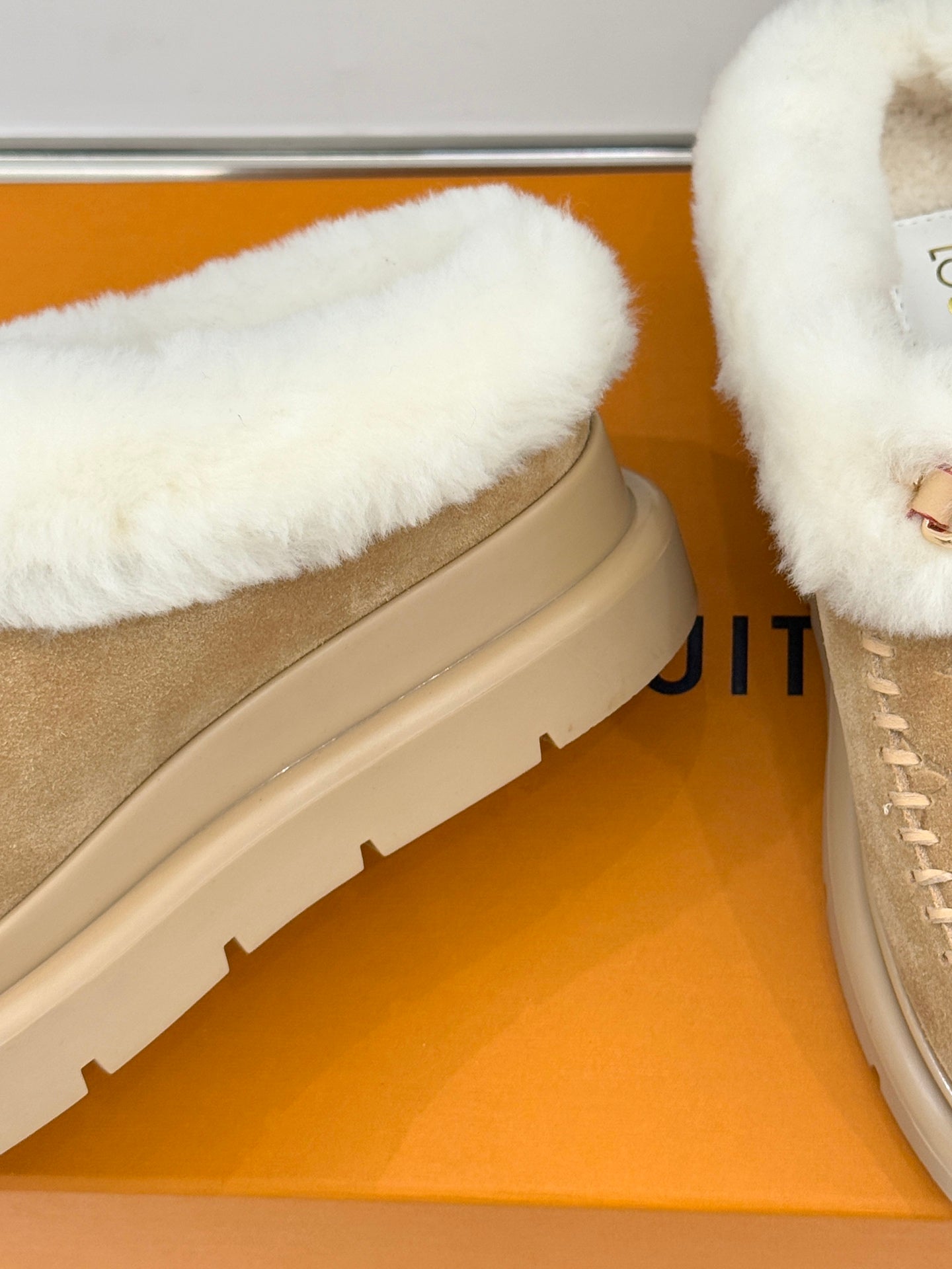 Ladies Louis Vuitton tan suede shearling slip-on shoe, close-up of thick sole