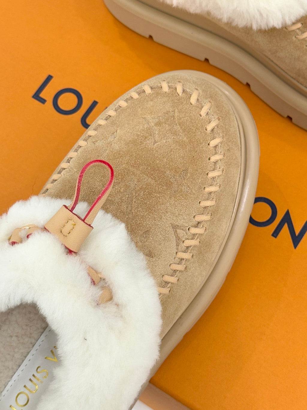 Ladies Louis Vuitton tan suede mule with white shearling and red strap on box