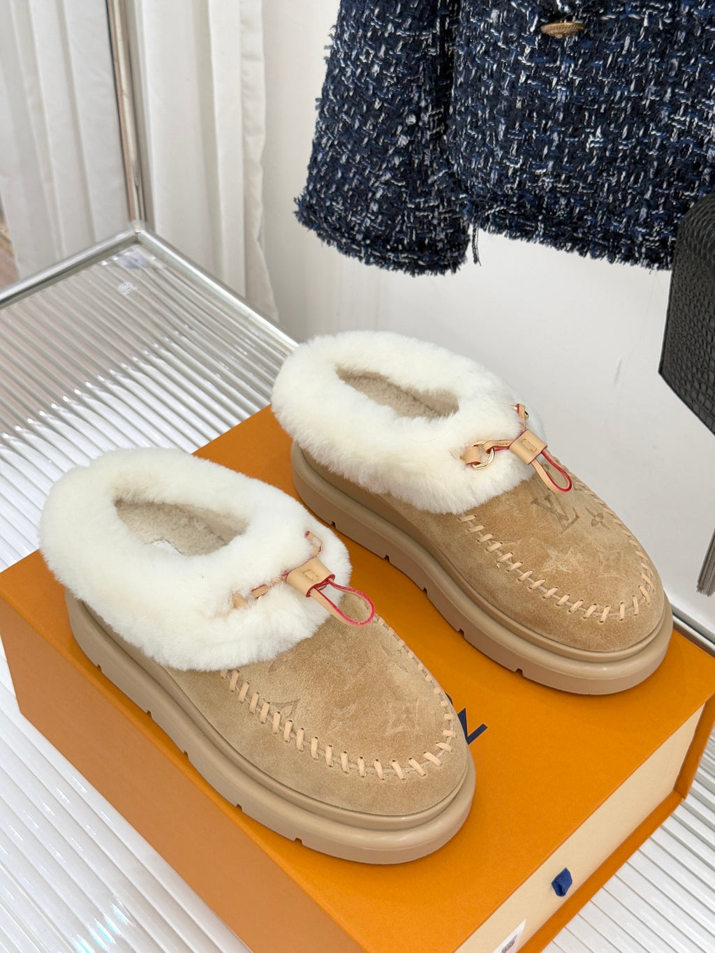 Ladies Louis Vuitton tan suede mules with white shearling strap detail
