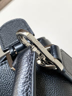 Loewe men's bag hardware close-up on textured dark blue leather with metal clasp