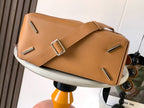 Tan leather crossbody bag with flap top, metal buckle, and strap detail.