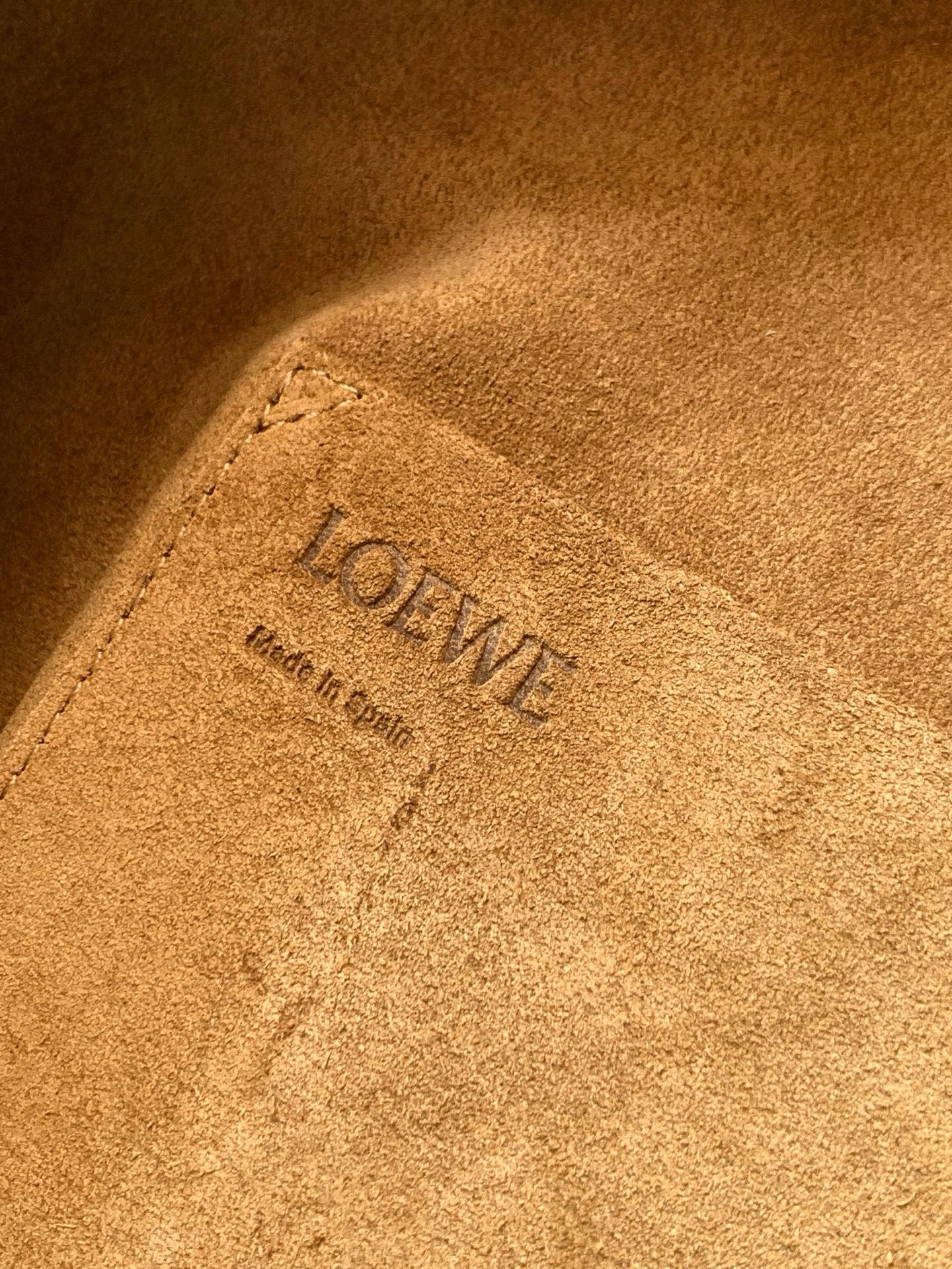 Loewe logo stamp on tan suede lining inside the bag, with embossed text detail