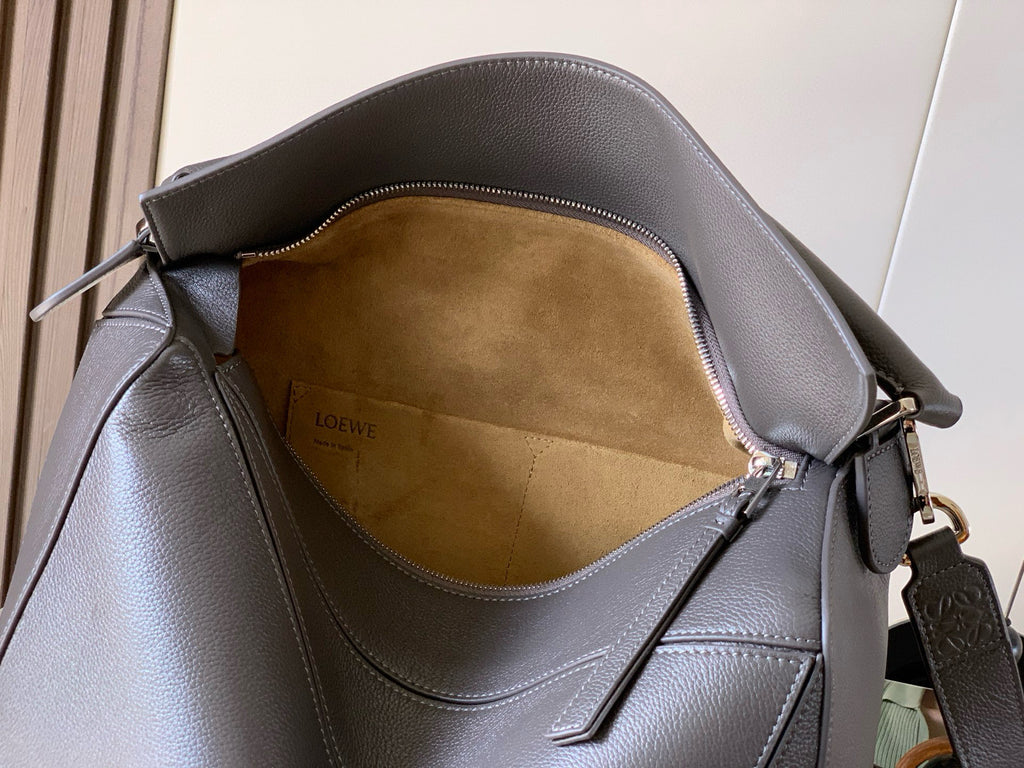 Men's shoulder bag interior view with tan suede lining and Loewe logo stamp