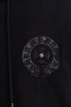 Black hoodie fabric with circular embroidered emblem patch