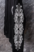 Black hoodie sleeve with large white ornamental graphic