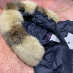 Long navy puffer coat with green faux-fur hood trim and front zipper detail