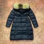 Long navy puffer coat with green faux-fur hood and belted waist, zip front